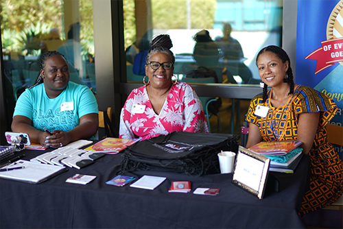 3 Black women working at a voter event