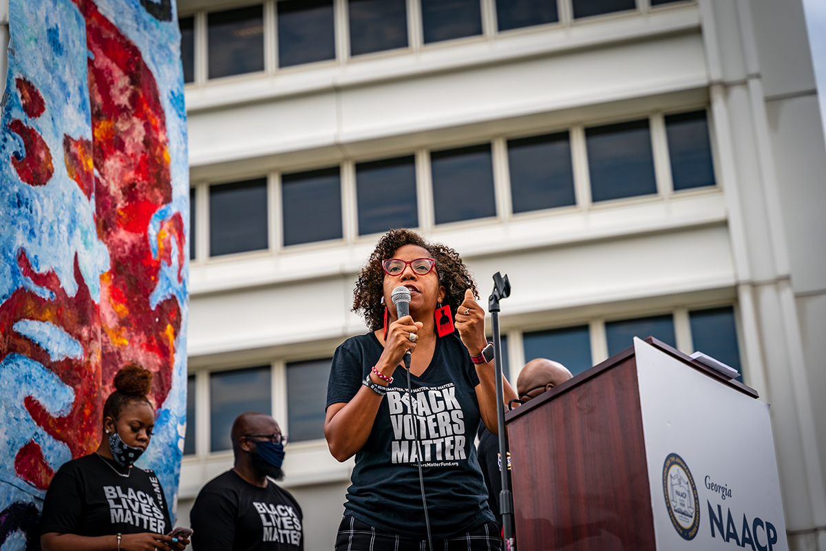Woman speaking at a Black Voters Matter rally